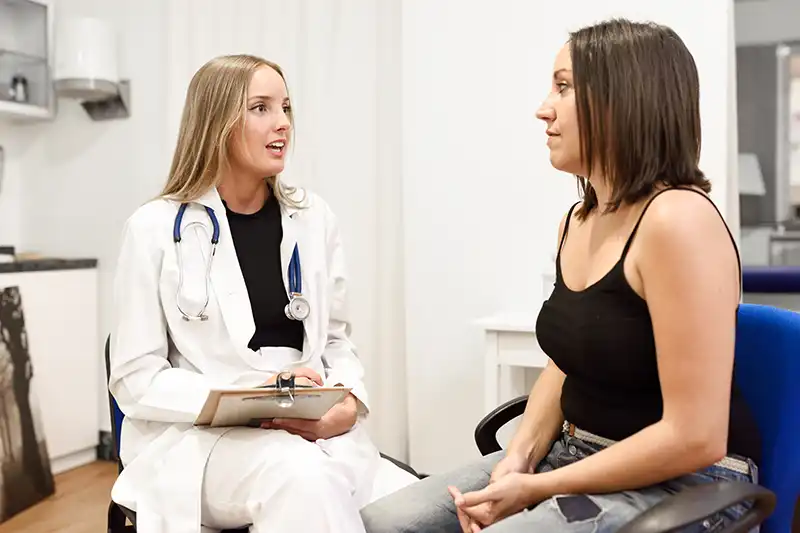 female doctor with ill patient in urgent care