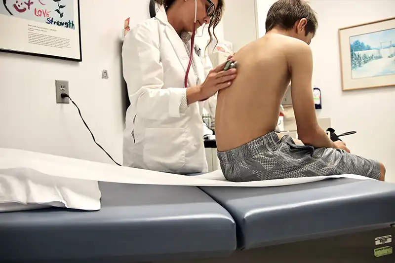young boy getting sports physical