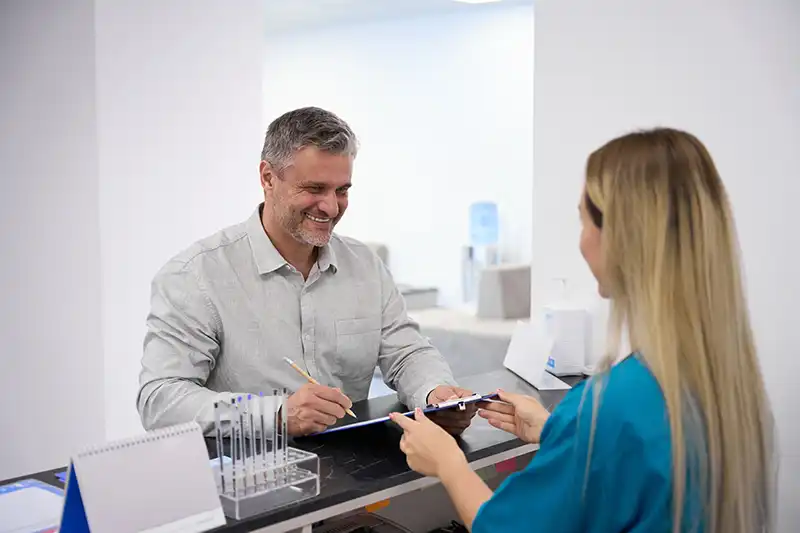 man signing medical clearance forms